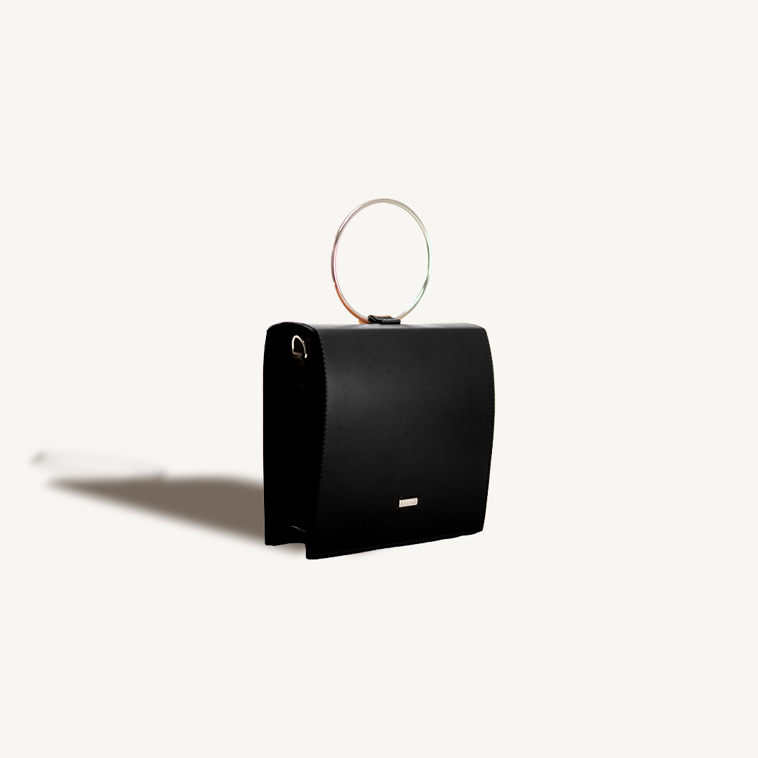 Black handbag with a circular handle on a white background